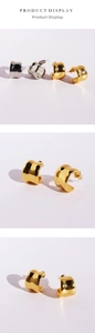 Close-up of modern chunky C-shaped hoop earrings in polished gold and silver finishes