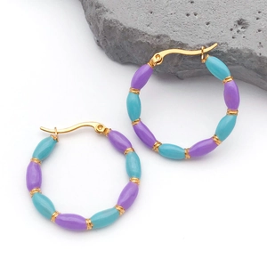 Detail of bohemian hoop earrings with blue and purple beads and gold-plated bamboo accents