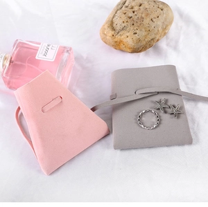 Pink and grey microfiber jewelry pouches with soft suede texture and elegant drawstring