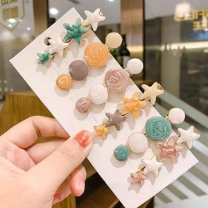 Five-piece colorful resin star and rose hair clips set displayed on a card