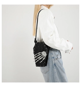 Detailed gothic black coffin-shaped crossbody bag with 3D bone hand and skull embossed pattern