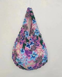 Detail of pink pleated bubble bag featuring colorful floral pattern and unique texture