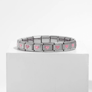 Detailed macro view of Italian charm bracelet links featuring pink enamel heart charms