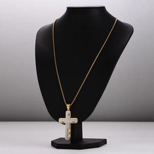 Hip hop style two-tone cross pendant necklace with golden chain on display stand