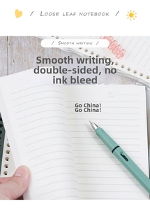 Detail of hand flipping pages of a B5 loose leaf notebook with a matching light green pen