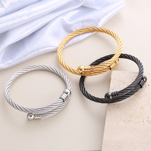 Three-piece stainless steel twisted cable bangles in gold, silver, and black finish