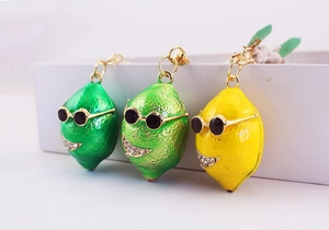 Tre portachiavi a forma di limone verde e giallo con dettagli in strass scintillanti