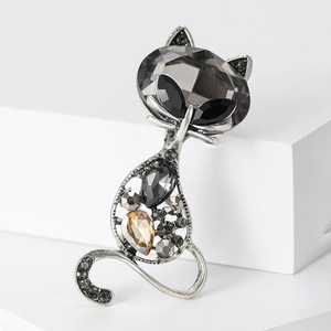 Macro view of crystal cat brooch featuring vintage silver alloy and grey gemstones