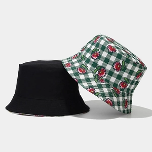 Close-up of black cotton and green plaid floral embroidered reversible bucket hats