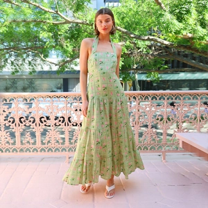 Close-up of halter neck backless floral dress with layered skirt and green flower pattern