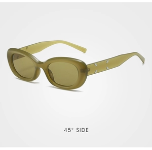 Detail view of olive green cat eye sunglasses with silver geometric accents and 45 degree angle