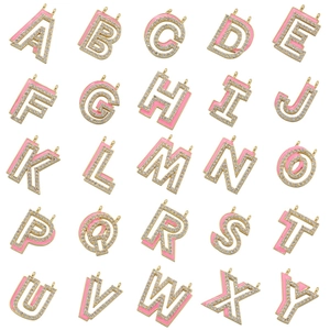 Detailed grid layout of 25 gold letter pendants with pink enamel and sparkling zircon
