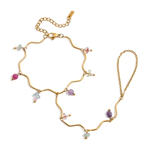 Detail of 18k gold plated finger bracelet featuring colorful natural stones and pearls