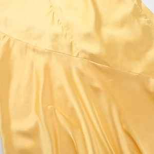 Macro view of luxurious yellow satin fabric texture and high-quality stitching detail