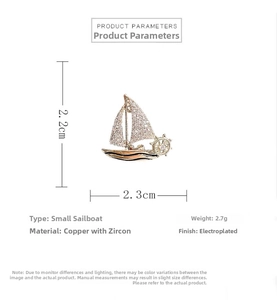 Detailed view of sailboat brooch measuring 2.2x2.3cm made of copper and cubic zirconia