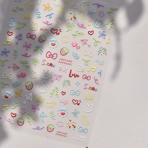 Detailed macro of 3D embossed nail stickers with macaron pastel cartoon patterns