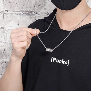 Fashionable titanium steel dumbbell pendant necklace worn by a model on grey background