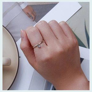 Detail shot of a s925 sterling silver ring featuring a cute dangling cat paw charm