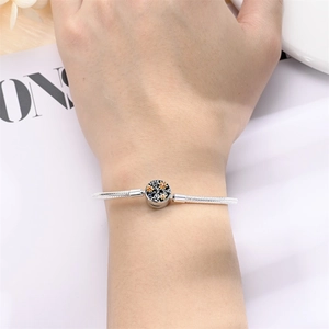 Silver snake chain bracelet with tree of life clasp and orange stones on wrist