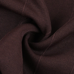 Macro shot of dark brown ribbed knit fabric showing the detailed vertical texture
