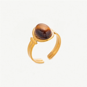 Macro shot of an adjustable gold ring featuring an oval tiger eye natural stone inlay