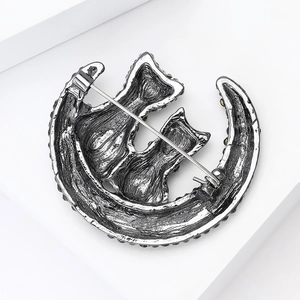 Detailed back view of cat moon brooch showing a secure pin and buckle fastener
