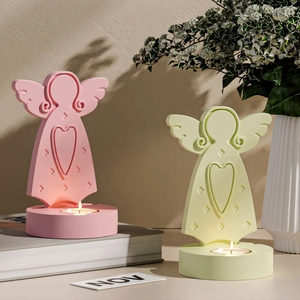 Minimalist angel candle holder set in pink and green with heart cutouts and tea lights
