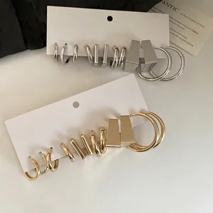 Minimalist C-shaped geometric hoop earring set in silver and gold finish display