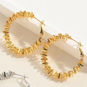 Macro shot of stylish gold and silver spiral hoop earrings with 925 hallmarked pins