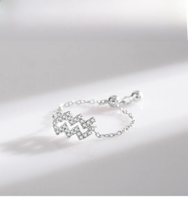 Close-up of wavy 925 sterling silver adjustable ring with pavé-set sparkling zircon crystals