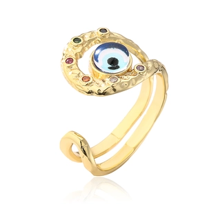 Macro shot of evil eye ring with hammered gold texture and colorful crystal details