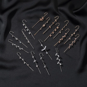 Minimalist crawler earrings with stars and zircon in gold and silver on black silk