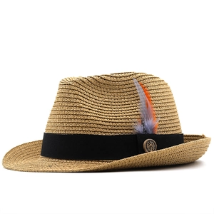 Detail of western straw hat featuring black ribbon band with anchor buckle and feathers