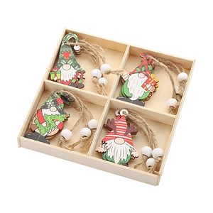 Detail of four unique wooden Christmas gnome ornaments with beads in a wooden storage box