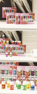 Close-up of 12-piece essential oil gift set featuring assorted scents and pink floral boxes