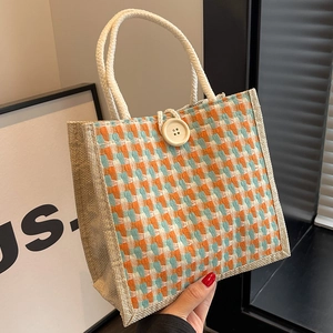 Handmade houndstooth jute tote bag in orange and blue with sturdy rope handles
