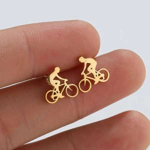 Minimalist gold-tone bicycle stud earrings for women and men shown for size reference