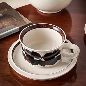 Detailed close-up of vintage ceramic coffee cup set with brown floral hand-painted pattern