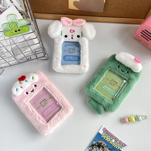 Macro detail of plush idol card holders in white, pink and green with soft textures