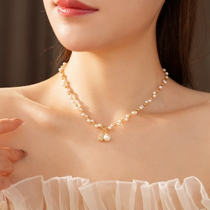 Model wearing a pearl necklace with a zircon gourd pendant on a gold chain