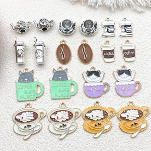 Detail view of coffee-themed enamel charms including teapots, cups and cats for DIY jewelry