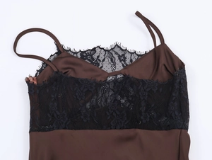 Detailed view of dark brown satin dress with black lace trim and delicate thin straps