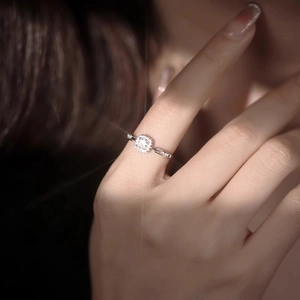 Sparkling silver square diamond ring with a chain design on a hand in soft lighting