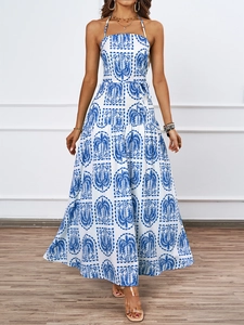 Detail of blue palm print halter dress with tiered skirt and high waist tie design