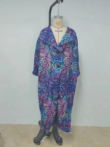 Detail of paisley floral print fabric and buttons on a purple bohemian coat