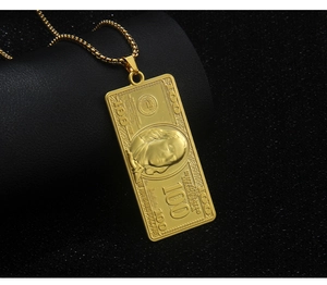 Detailed close-up of a gold-plated 100 dollar bill pendant with embossed dollar textures