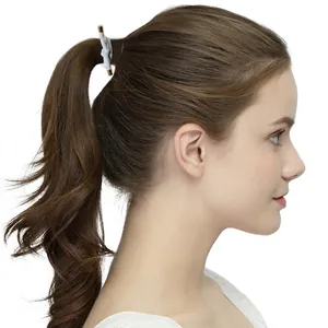 Minimalist threaded knot hair tie with golden metal caps on a ponytail hair style
