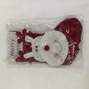 Detail of red knitted Christmas stocking with plush trim and Santa Claus in packaging