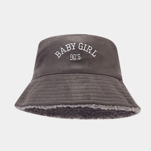 Detailed view of dark grey faux suede bucket hat with soft sherpa lining and 90'S embroidery