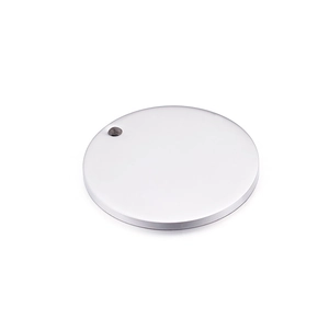 Close-up of a polished round stainless steel pendant charm with a small hole for DIY jewelry